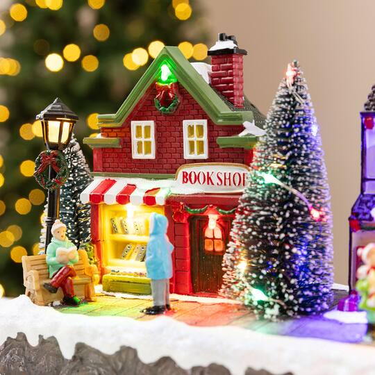 Glitzhome® 15.75" Lighted Christmas Resin Shop Avenue Musical Village with Timer